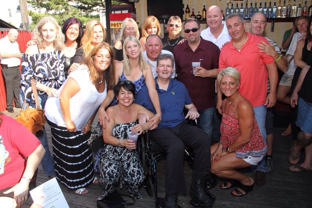 Family and friends happily supported Ed Smith (center) in a benefit to help pay for medical expenses associated with his ailment.